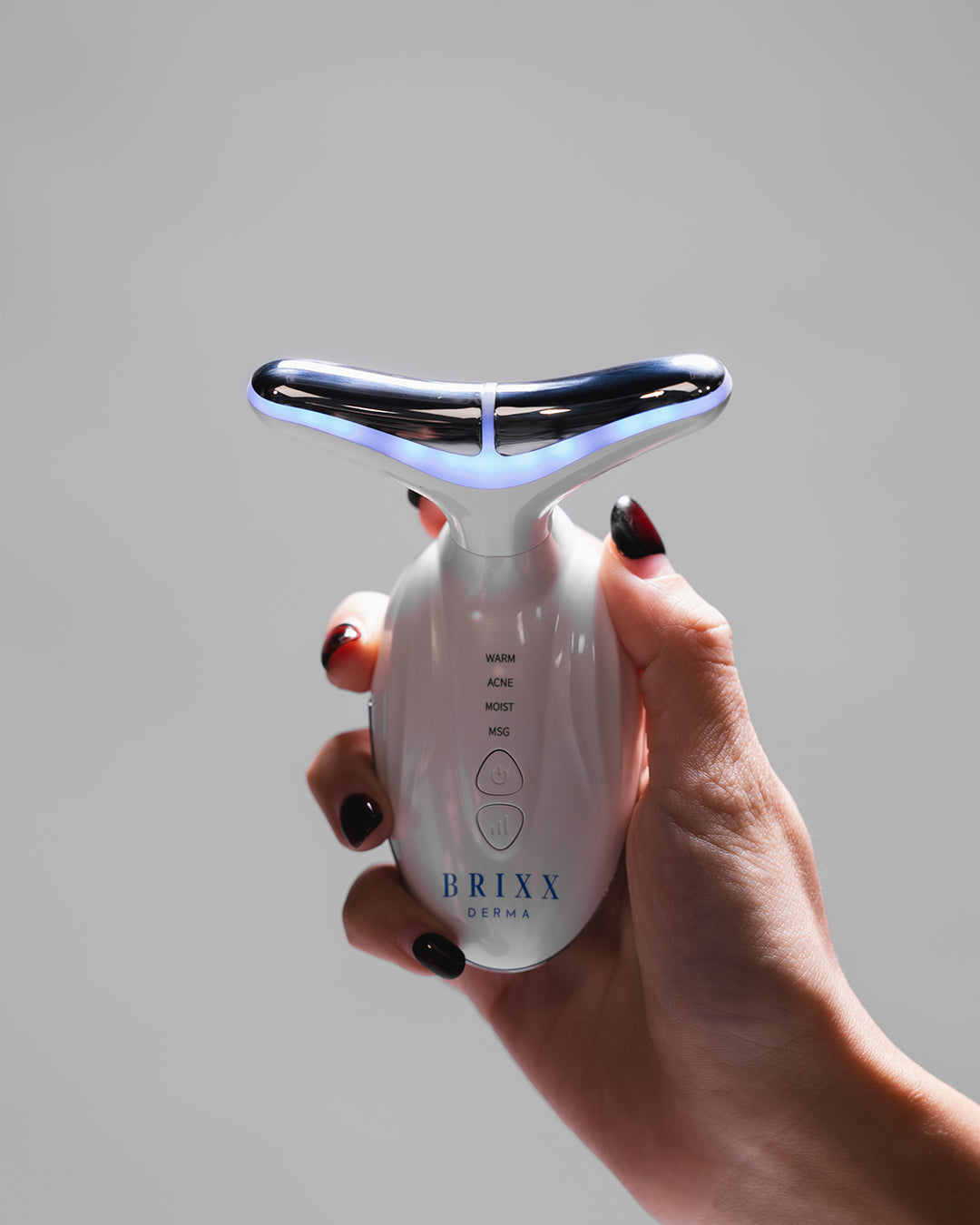 Hand holding Sculpta-V with 'BRIXX' branding against a gray background